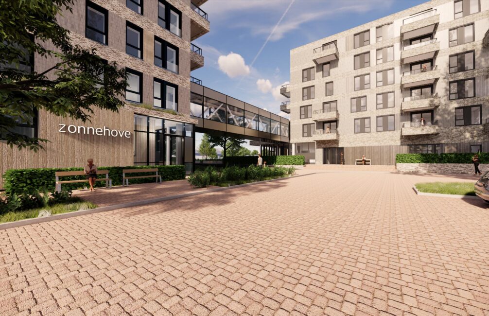 Afbeelding van een modern appartementencomplex met meerdere verdiepingen, omgeven door groen en een geplaveide binnenplaats.