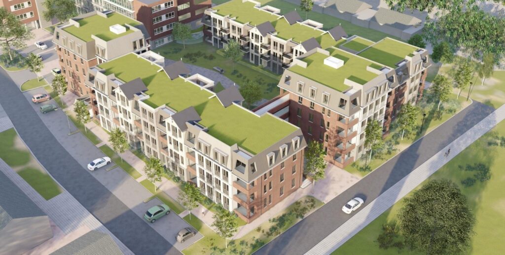 Luchtfoto van een modern appartementencomplex met groene daken, omgeven door wegen en groenvoorzieningen in een stedelijke omgeving.