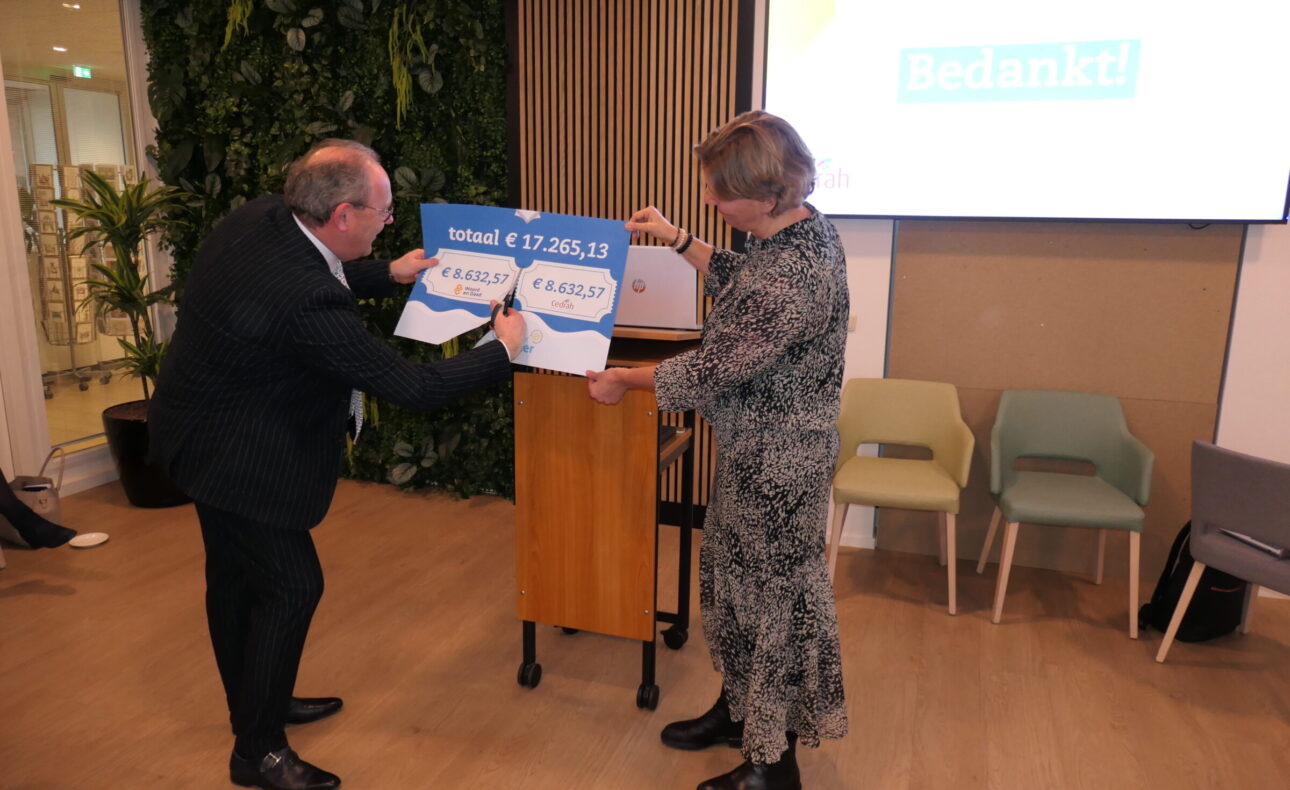Een man en een vrouw knippen de cheque door