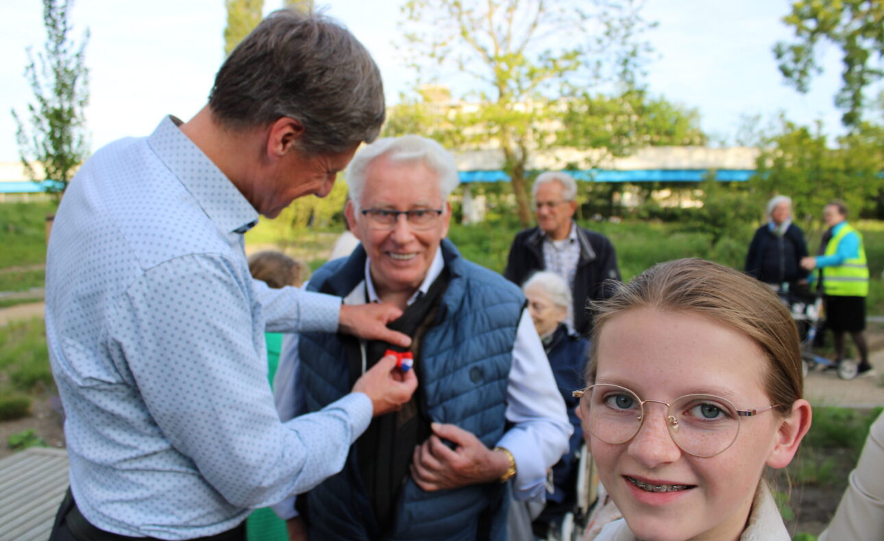 Man speldt oudere man een speldje op